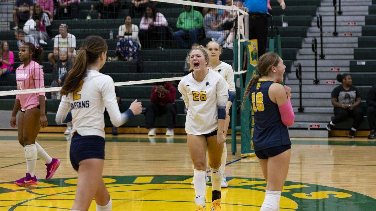 Sayre’s Jayda Davis (26) celebrates a point with her teammates during the Spartans’ five-set victory at Bryan Station High School on Tuesday.