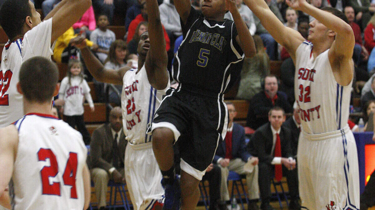 Henry Clay's Felix Wilson shot in a crowd of Cardinals on Thursday in the 43rd District finals. Wilson scored 12 points.
  