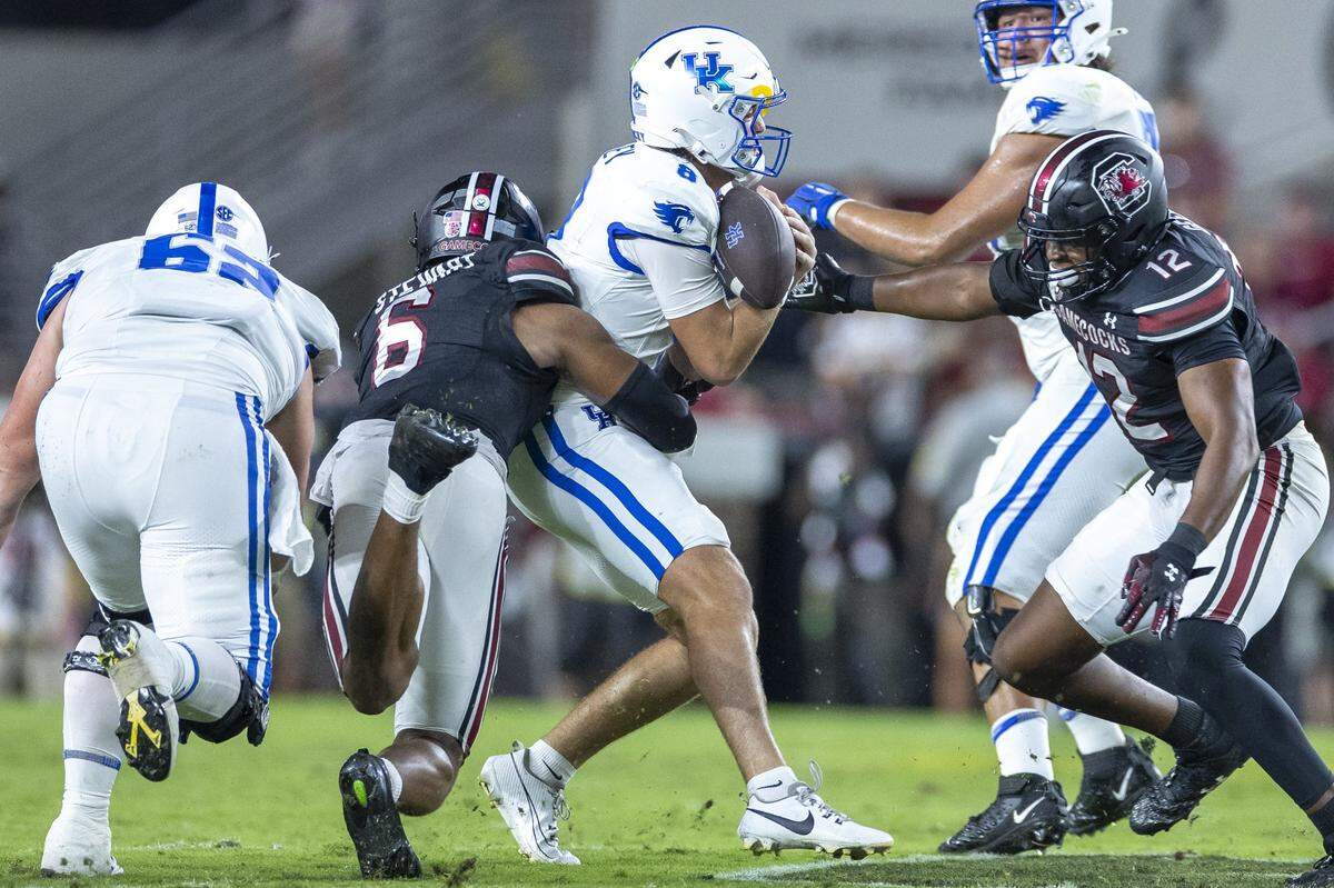 Kentucky quarterback Cutter Boley (8) loses the ball as he’s hit by South Carolina linebacker Dylan Stewart (6) during Saturday’s game at Williams-Brice Stadium in Columbia, S.C.