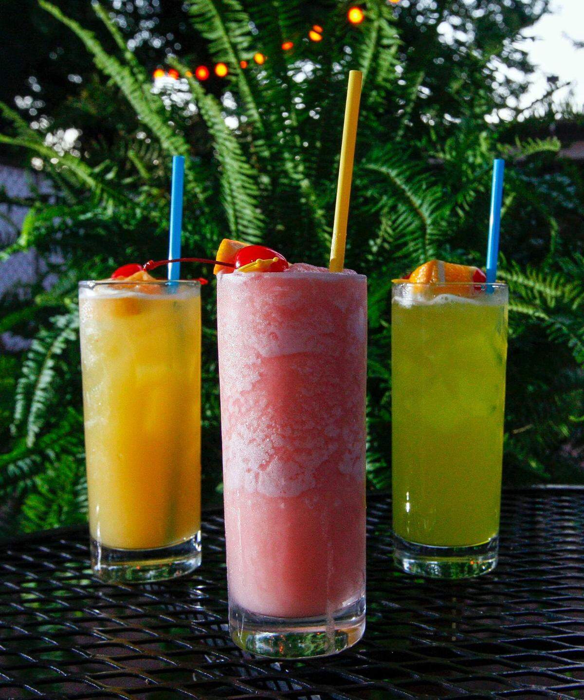 Champagne Caribe, center, was a popular drink order at Lexington’s Atomic Cafe on North Limestone. At left is a Yellow Bird and at right is the Atomic Palm.