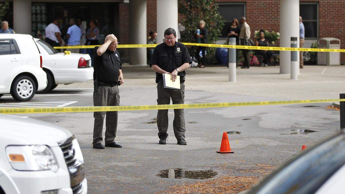 David Bochenek, left, and Tim Ballinger of the Lexington Police Forensic Unit worked the scene of a shooting at the Northpoint/Lexington Healthcare Center on Tuesday.
