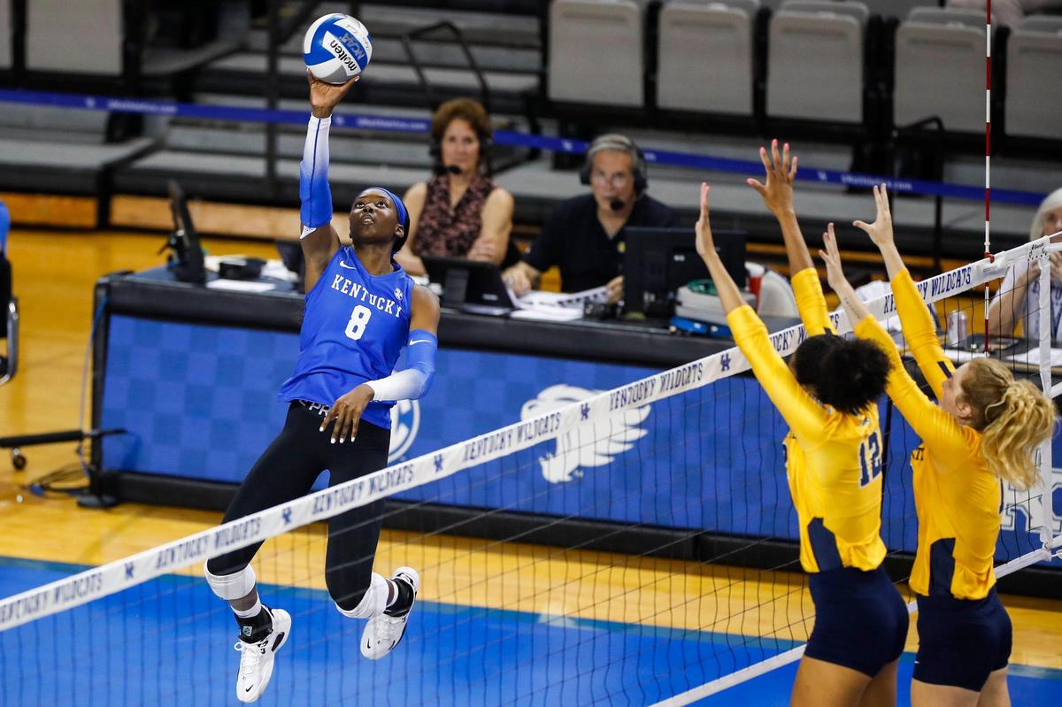 Outside hitter Adanna Rollins (8) spikes the ball against Marquette during Kentucky’s season opener on Friday night. Rollins joined UK as a transfer from Penn State this offseason.