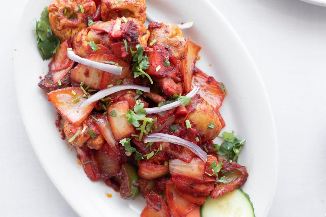 Vegetable chili momo at Everest Nepalese and Indian Cuisine is comprised of steamed dumplings dipped into sesame- and tomato-based mixed soup.