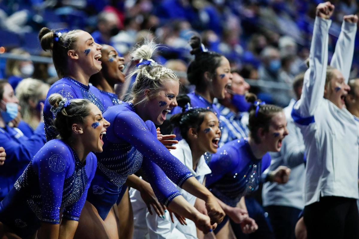 The Kentucky gymnastics team cheers on junior Raena Worley in the floor routine as the Wildcats won their season-opening meet in Rupp Arena.