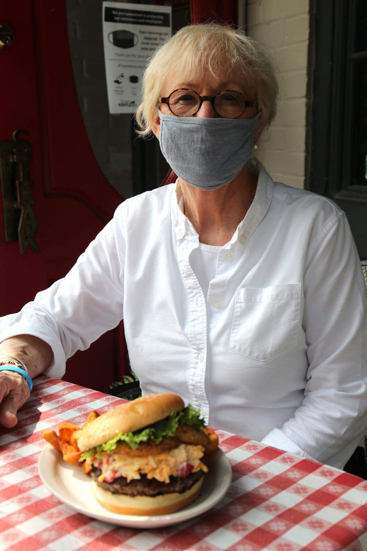 Hostess Flo Cowley with Columbia Steakhouse Downtown’s Burger Week offering, South in Your Mouth.