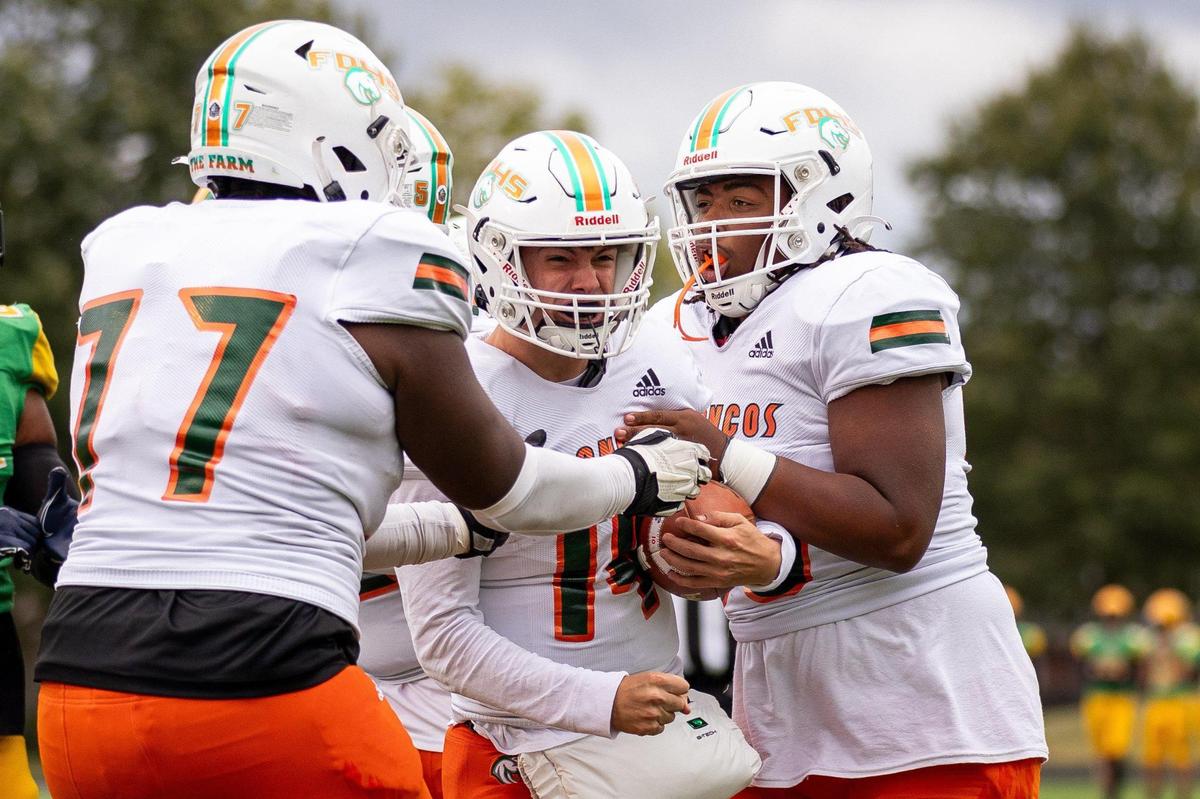 Frederick Douglass quarterback Jaxon Strautman (14) celebrates after scoring a a touchdown at Bryan Station on Saturday. Strautman also passed for two touchdowns.