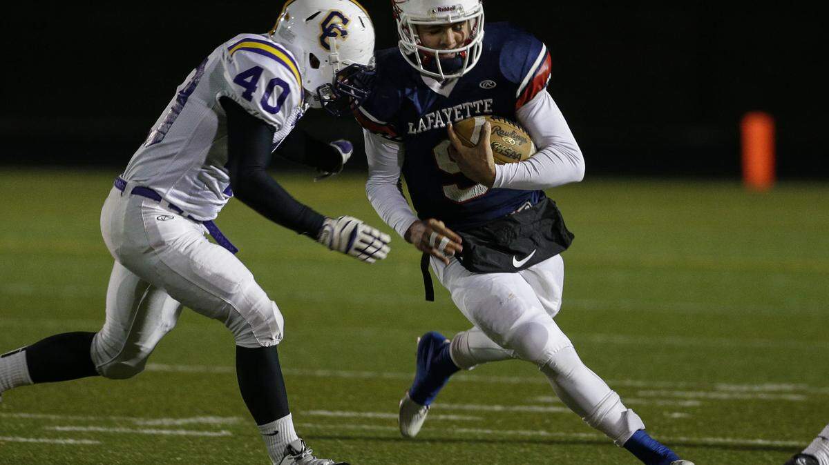 Lafayette's Walker Wood went around the end on Campbell County's Jimmy Garland, 40, as Lafayette played Campbell County  on Friday November 7, 2014  in Lexington, Ky.