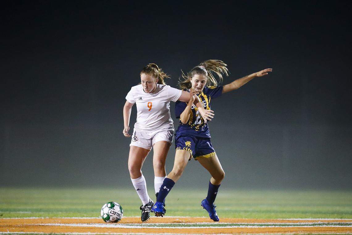 Frederick Douglass’ Emily Coke (9) and Sayre’s Gigi Cornett (21) battle for the ball during the 42nd District semifinals at Frederick Douglass High School in Lexington, Ky., Wednesday, Oct. 9, 2019.