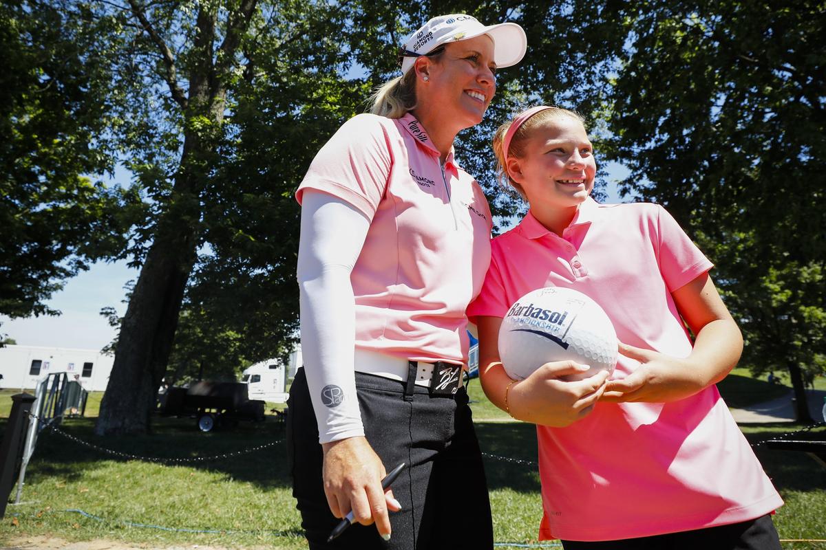 Brittany Lincicome posed for a picture with Channing Hagan, 11, of Lexington, after her round during the PGA Tour Barbasol Championship at Keene Trace Golf Club Thursday.