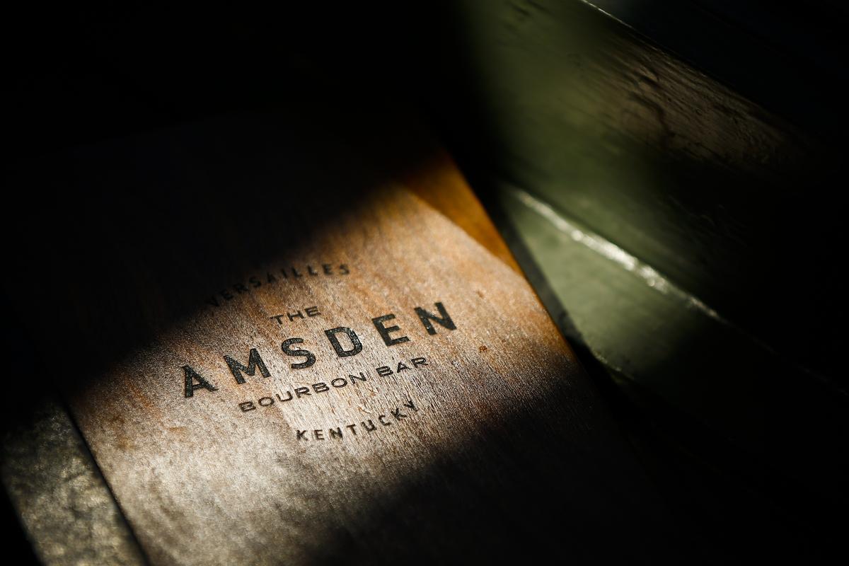 The drink menu sat in sunlight Tuesday at The Amsden Bourbon Bar in Versailles. The Amsden Bourbon Bar is open daily and features seasonal and classic cocktails.