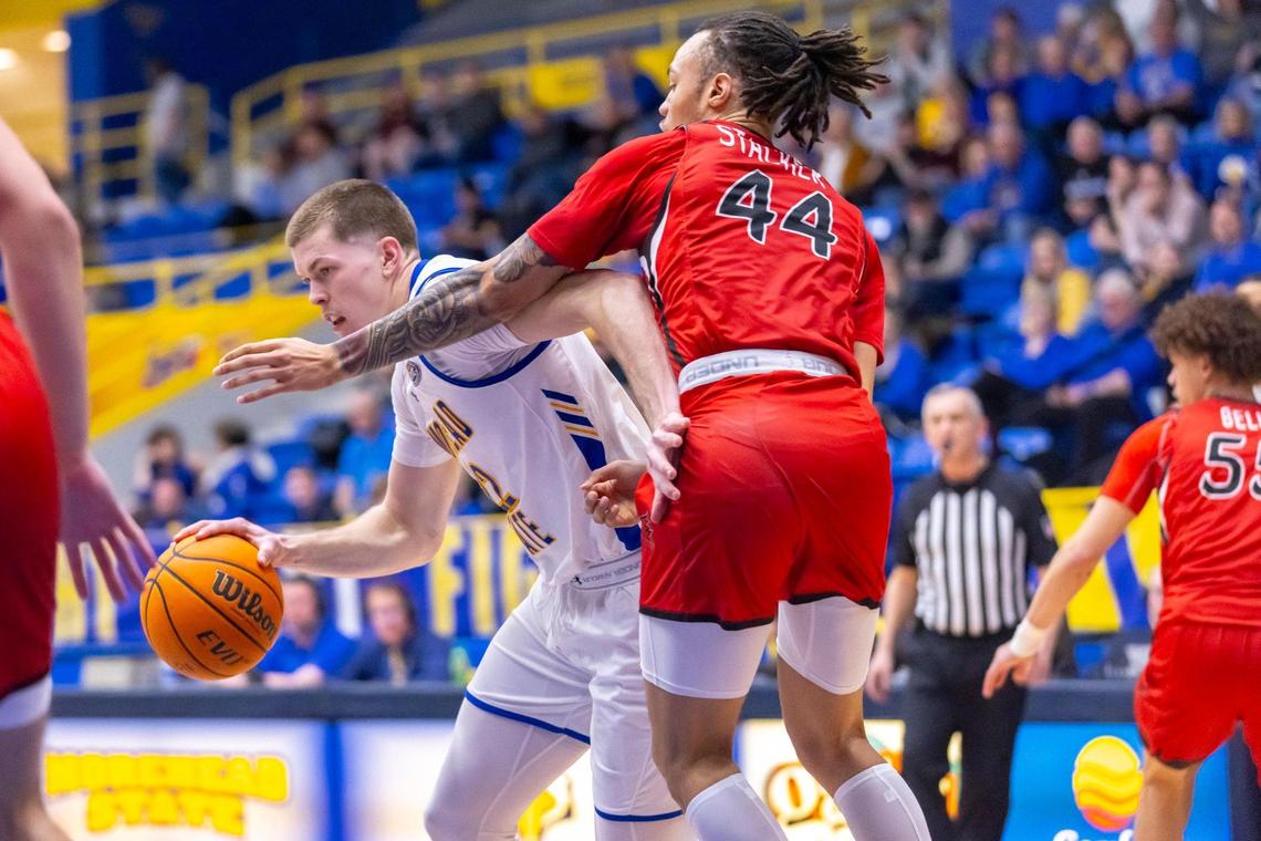 Morehead State guard Riley Minix (22) drives the ball as Southeast Missouri State guard Braxton Stacker (44) defends during a game at Johnson Arena in Morehead on Feb. 29. Minix is the 2024 Ohio Valley Conference Player of the Year.