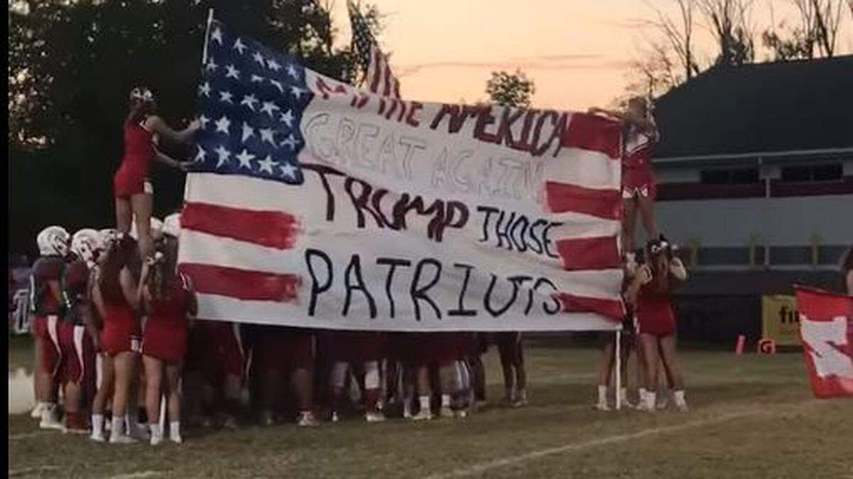 Cheerleaders from Anderson County High School held a banner Friday with a Donald Trump slogan on it.