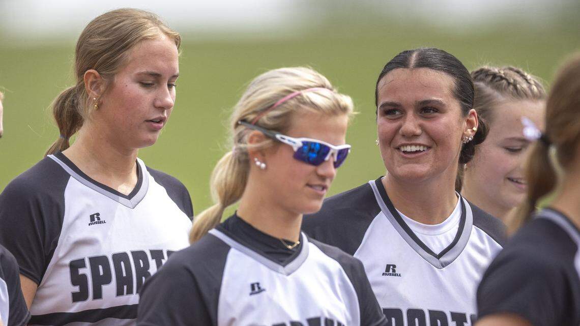 South Warren’s Layla Ogden, right, smiles as her teammates, including, Courtney Norwood, left, and Hadley Borders, walk off the field following their 15-0 win in three innings over Frederick Douglass at Great Crossing Park in Georgetown on Saturday.