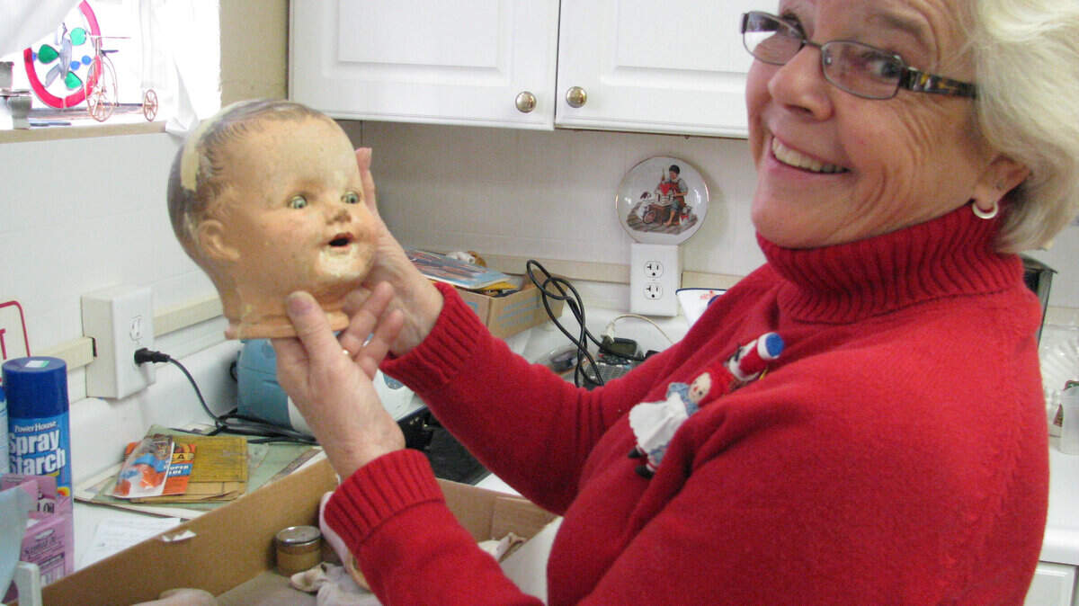 "The bottom line is I like things that were played with, and that have been played with," said curator Jan Taylor, who makes simple repairs on vintage dolls in the museum's workshop.         