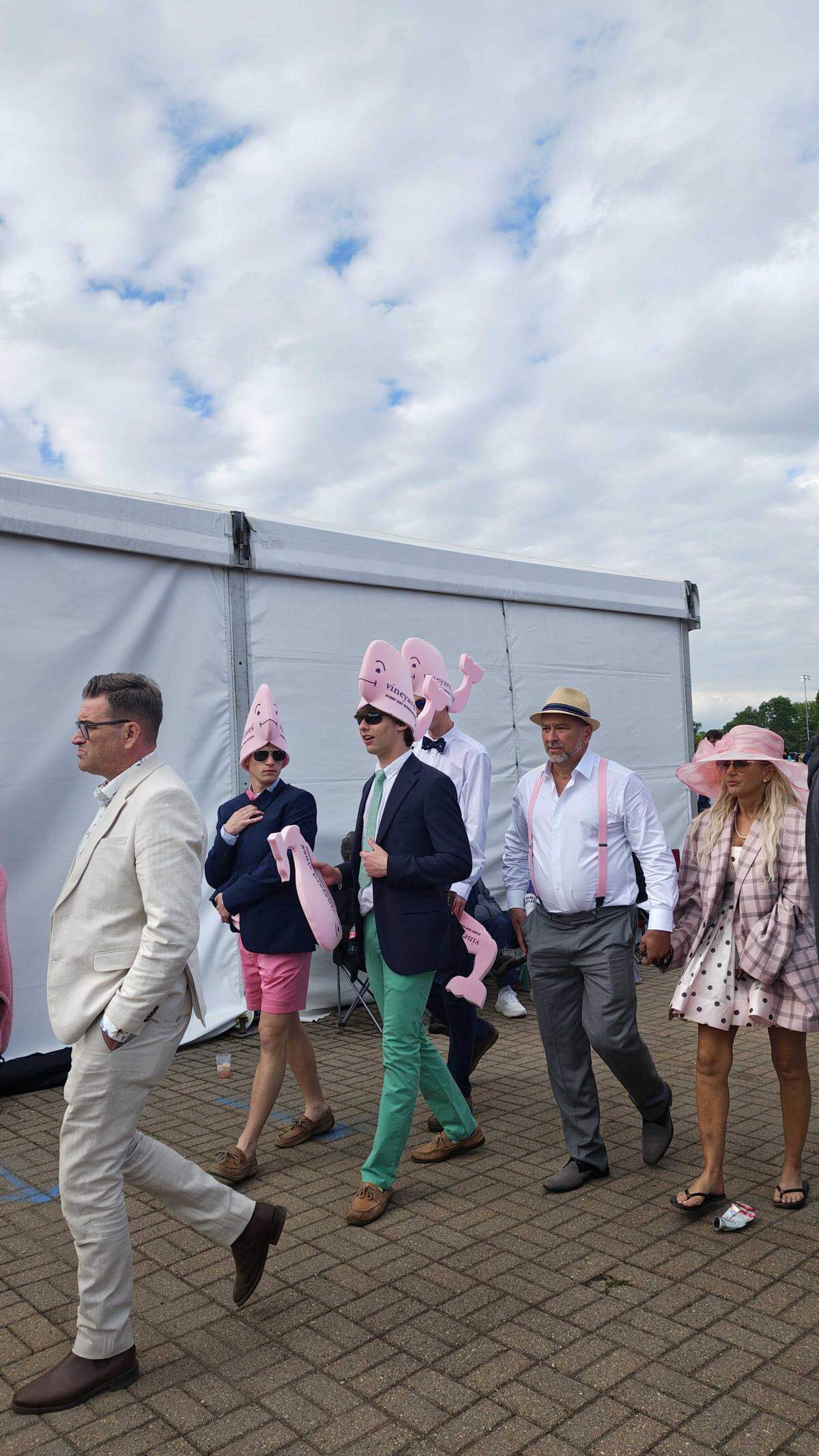 Attendees at the Kentucky Derby stroll through the infield.