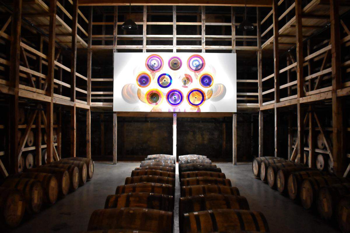 “Wall of Echoes” features 10 grouped pieces from Powell’s Echo series. It is situated in a a large theater-like space surrounded by thousands of barrels of Maker’s Mark.
