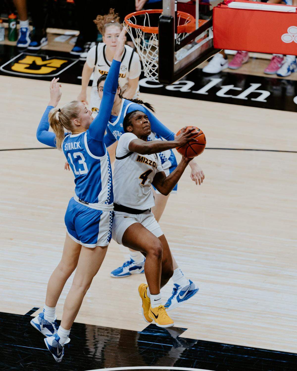 Kentucky’s Clara Strack (13) attempts to block a shot by Missouri’s Laniah Randle during the Wildcats’ win in Columbia on Thursday night. Strack led UK with 22 points and 12 rebounds and blocked two shots.