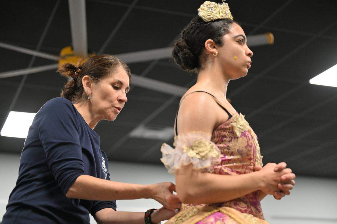 Bluegrass Youth Ballet founder and director Adalhi Aranda adjusts dancer Kayla Chambers-Reed’s costume during a “Nutcracker” rehearsal. Bluegrass Youth Ballet rehearsed for its 2024 edition of “Nutcracker In One Act” at its studios on Southland Drive in Lexington, Kentucky on Dec. 14, 2024.
