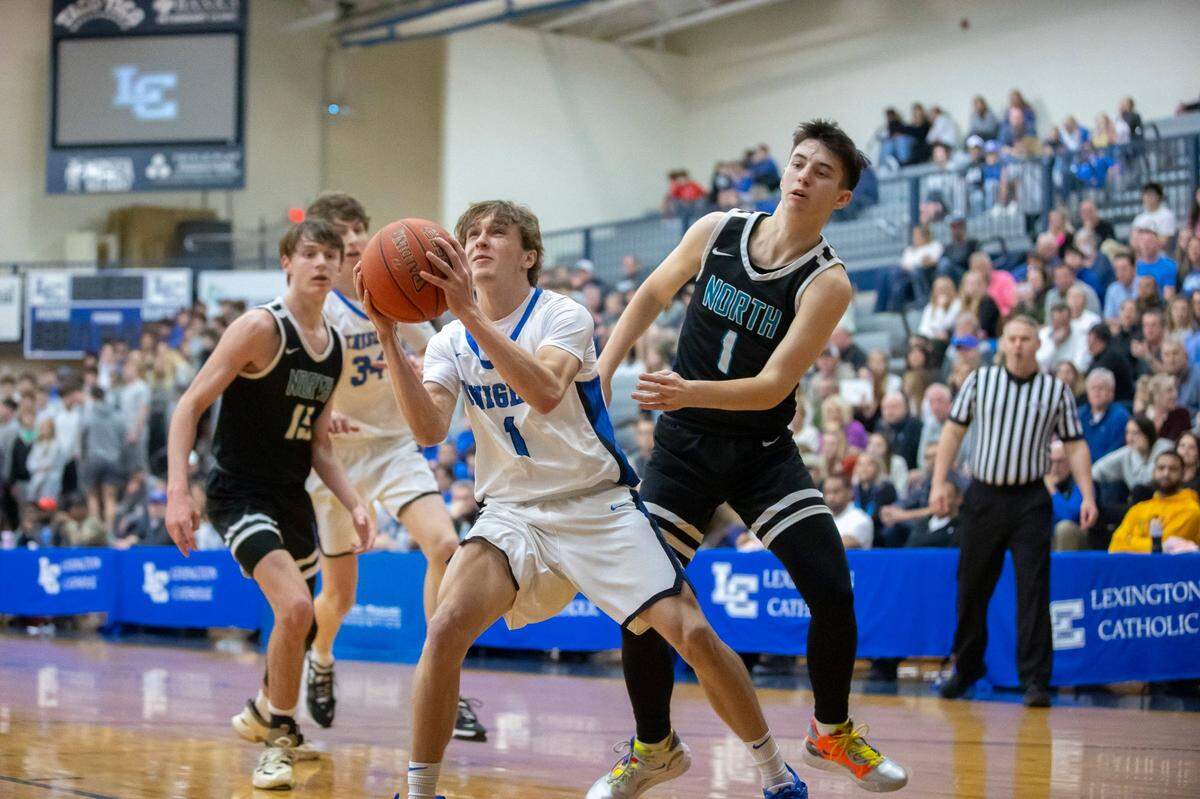 Lexington Catholic’s Sam Clements (1) shoots the ball in front of North Oldham’s Dallas Roberts (1) during the championship game at the White, Greer & Maggard Holiday Classic at Lexington Catholic High School in Lexington, Ky., on Friday, Dec. 30, 2022.