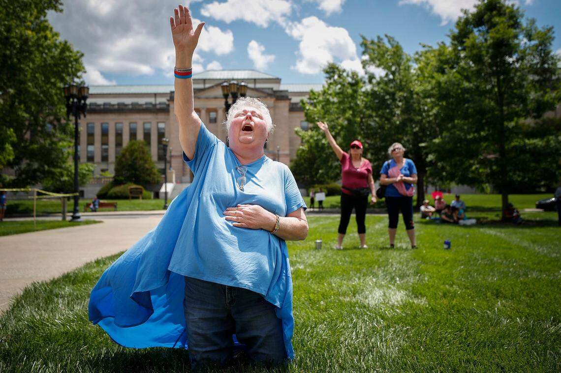 Janice Roberts, of Louisville, Ky., a member of Evangel World Prayer Center church, sings out in prayer during a “prayer rally” at the state Capitol in Frankfort, Ky., Saturday, May 30, 2020.
