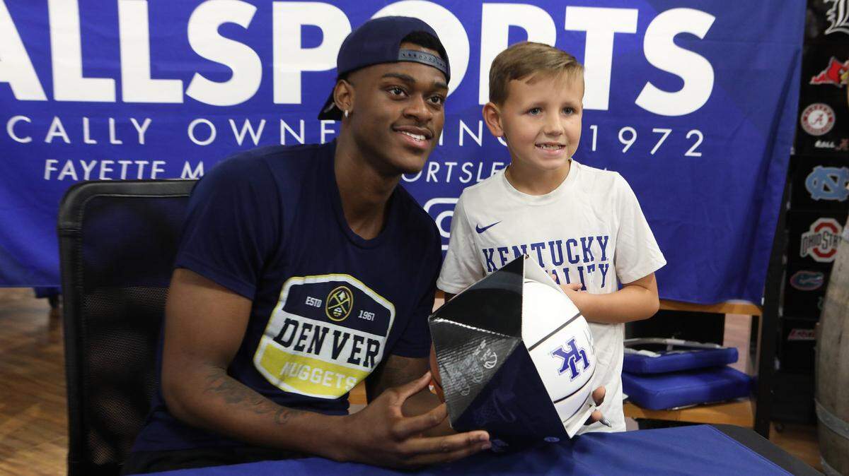Aiden Hall, 8, of Nicholasville posed with former UK player Jarred Vanderbilt on Tuesday evening during an autograph session at Allsports in Fayette Mall.