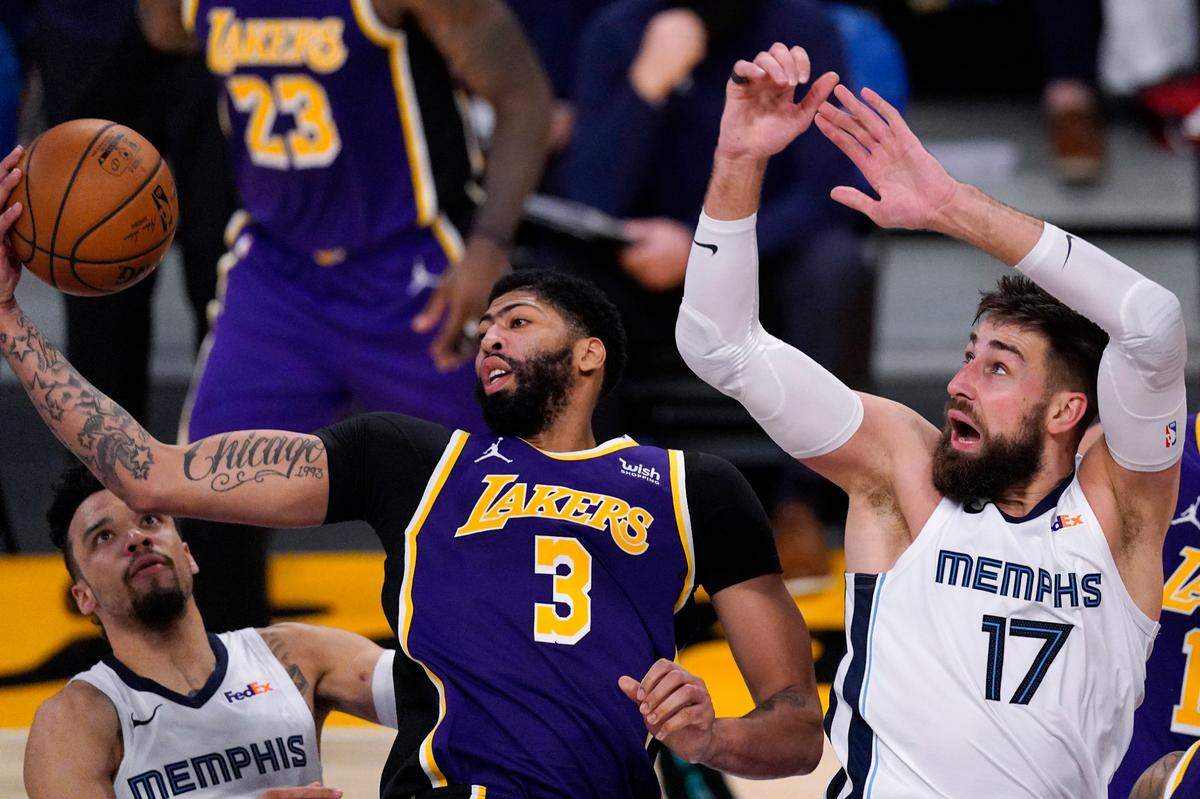 The Lakers’ Anthony Davis, center, grabbed a rebound away from the Grizzlies’ Dillon Brooks, left, and Jonas Valanciunas on Feb. 12. Davis was named an NBA All-Star for the eighth time on Tuesday night.