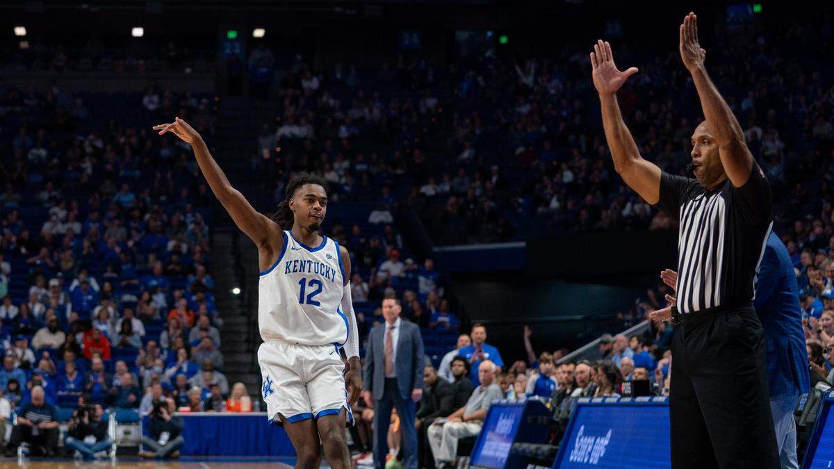 Kentucky’s Antonio Reeves (12) celebrates making a 3-pointer against Georgetown College during Friday’s exhibition game.