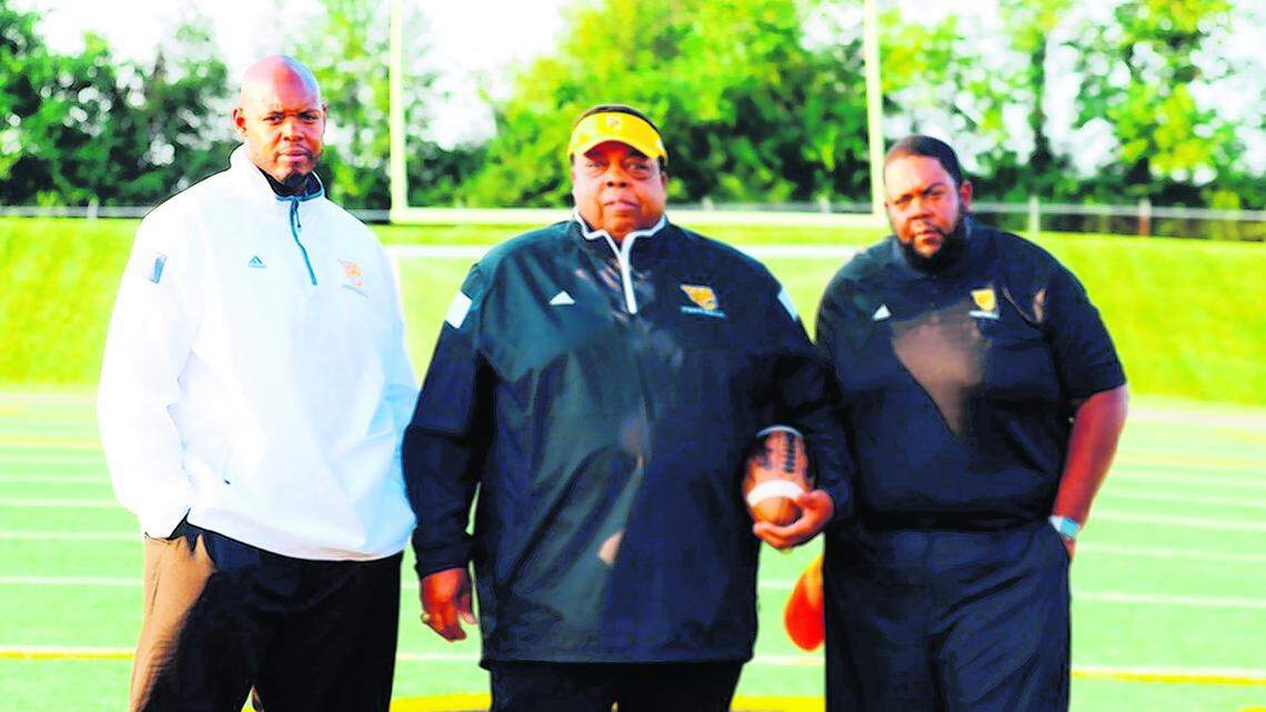 Woodford County head football coach Dennis Johnson, left, with his father Alvin, center, and brother Derrick. (Photo submitted)
