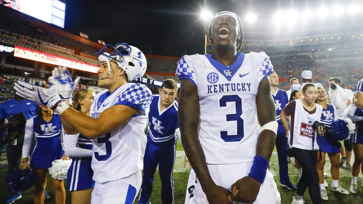 Kentucky quarterback Terry Wilson (3) celebrated after Kentucky’s 27-16 victory over the Florida Gators during their game Saturday at Ben Hill Griffin Stadium in Gainesville.