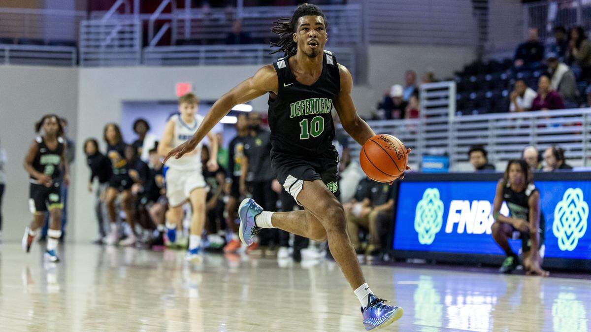 Bryan Station's Amari Owens (10) drives to the basket during Lexington Catholic's 42-41 win over the Defenders in the quarterfinals of the boys basketball 11th Region Tournament, Wednesday, March 4, 2026 at Eastern Kentucky University's Baptist Health Arena in Richmond, Ky.
