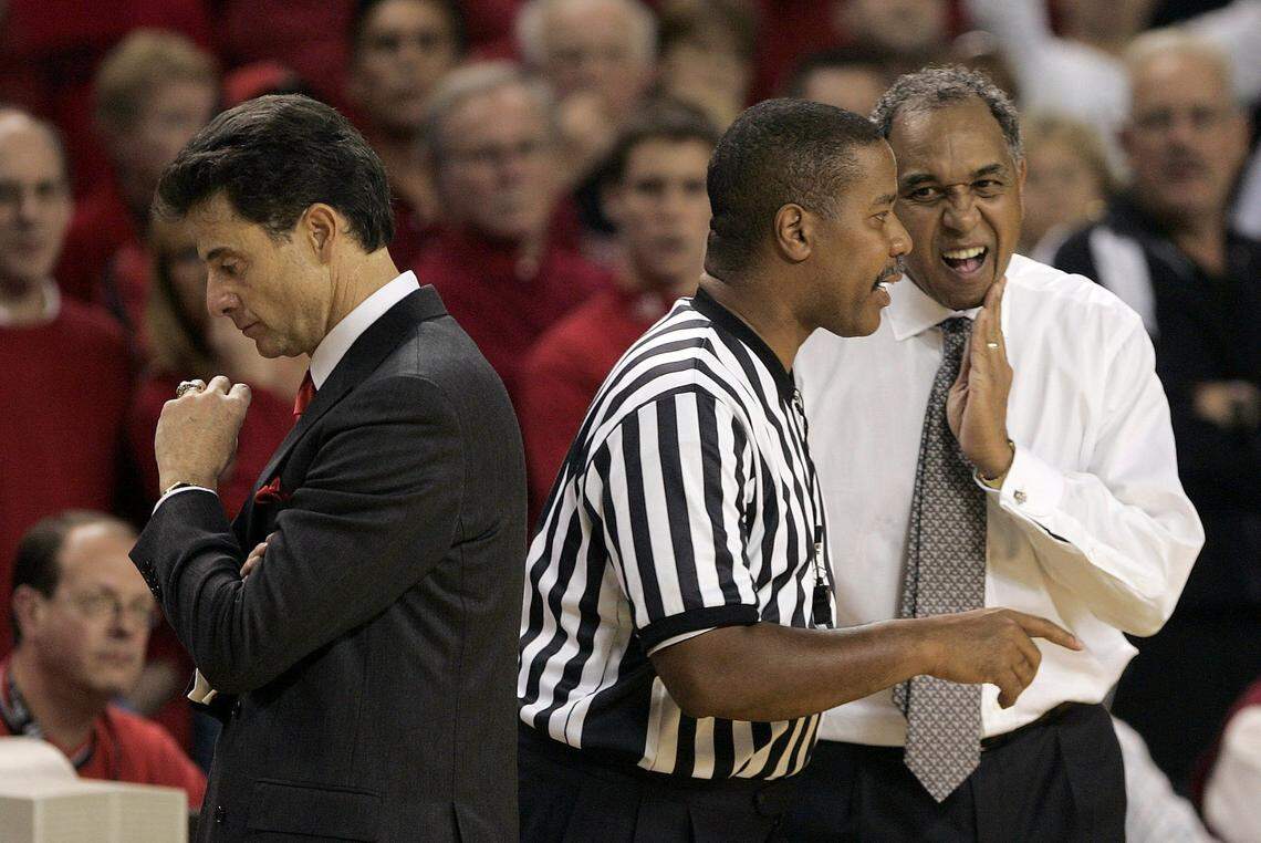 Louisville coach Rick Pitino, left, heads back to the bench as referee Gerald Boudreaux talks with Kentucky’s Tubby Smith during UK’s 60-58 win over the Cards on Dec. 18, 2004.