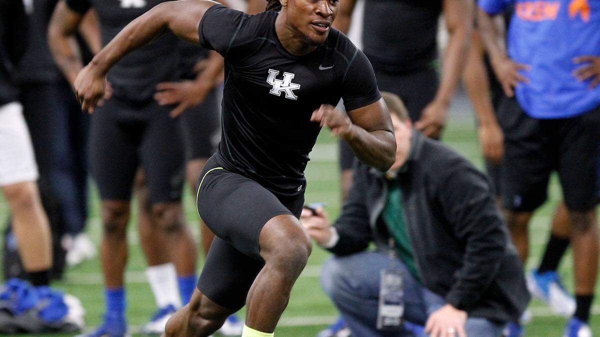 Cornerback Cartier Rice sprinted for scouts during UK's annual Pro Day for graduating football seniors held in the Nutter Field House on the UK campus in Lexington Ky., Thursday, March 21, 2013. The players will had the opportunity to go through the 40-yard dash, pro shuttle, vertical jump and additional skills in front of NFL officials and scouts. Photo by Charles Bertram | Staff





