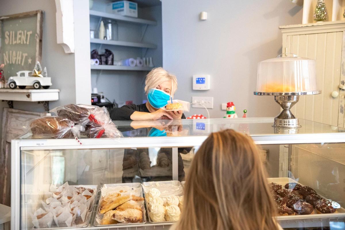 Beth Carter, owner of B’s Bakery puts a candle in a donut and sings happy birthday to Ella Simpson, who just turned 9, on Friday, Nov. 13, 2020. The bakery was selected by the Food Network as one of the 10 bakeries in the United States serving the cutest food.