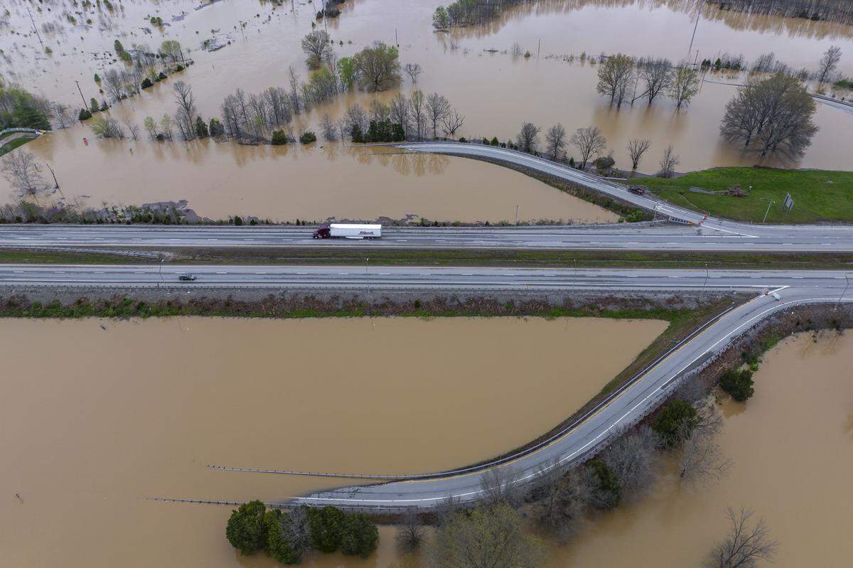An on- and off-ramp, which have been closed, are covered by water at Exit 10 on the Bluegrass Parkway in Nelson County on Monday, April 7, 2025.  