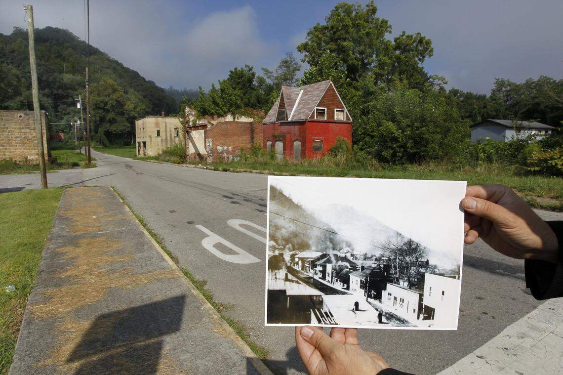 Mark Bailey held a photo showing what Wallins Creek, in Harlan County, looked like in the 1920’s, compared to how it looked in 2011. The first load of coal shipped by rail from the county 100 years earlier was mined near the town.