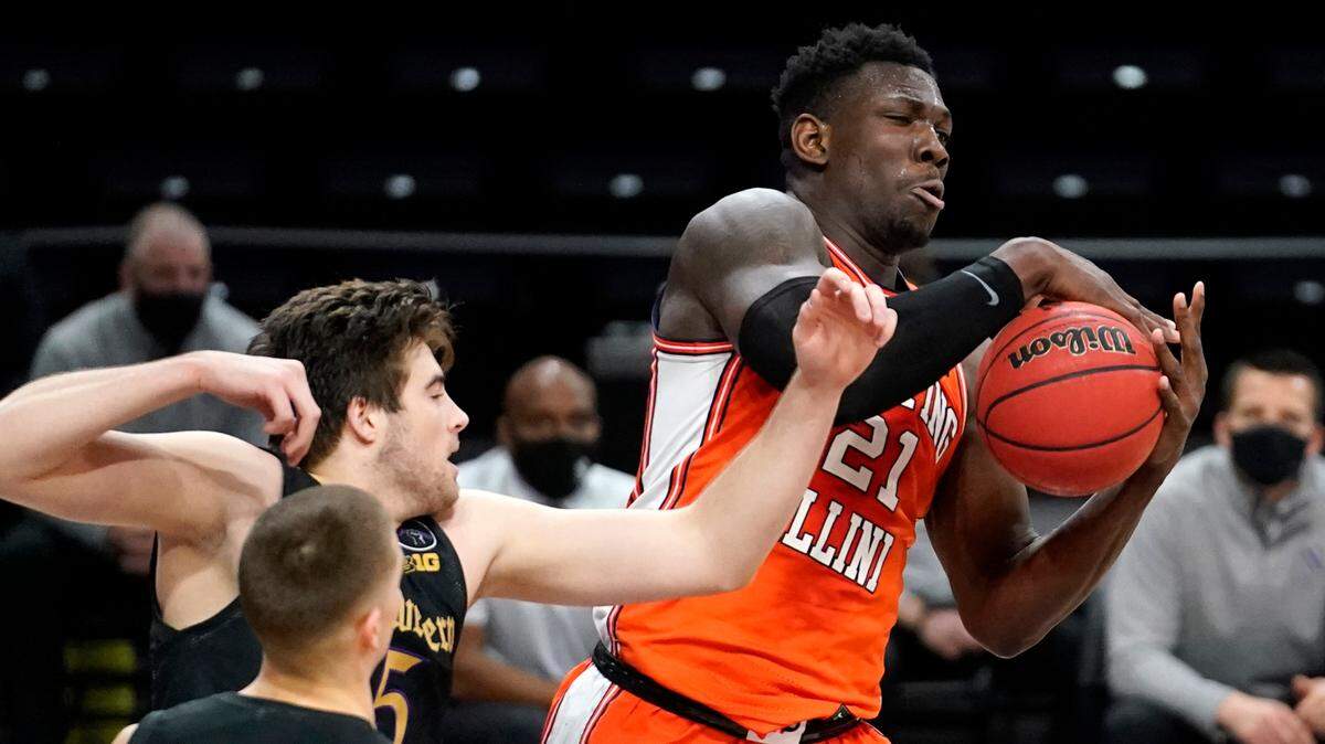 Illinois center Kofi Cockburn, right, rebounded the ball against Northwestern on Jan. 7.