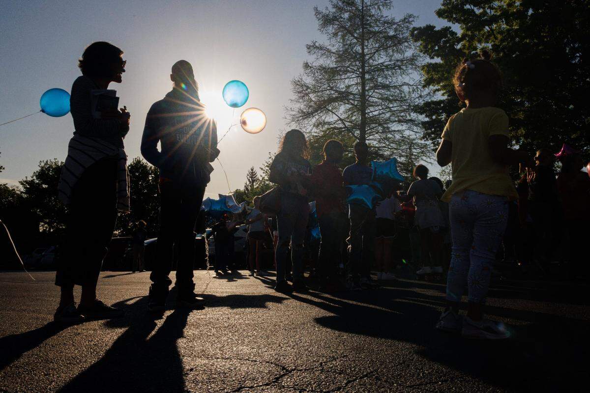 Members of the community and FaithPointe Church gather during a vigil on Monday, May 9, 2022, at Parkway Plaza Apartments in Lexington, Kentucky, for Skyler Williams, 5, and Deon Williams, 13, who were killed last week. Their mother has been accused of killing the two children.