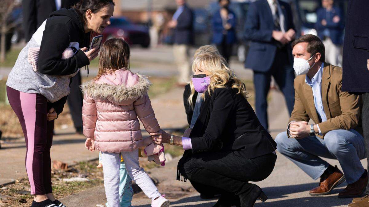 First lady Jill Biden and Kentucky Gov. Andy Beshear, right, greet the Mustafa family that was affected by a tornado in Bowling Green, Ky., Friday, Jan. 14, 2022. The Bowling Green neighborhood was one of several areas hard hit by Dec. 10 tornadoes that tore through the western part of Kentucky. (AP Photo/Michael Clubb)
