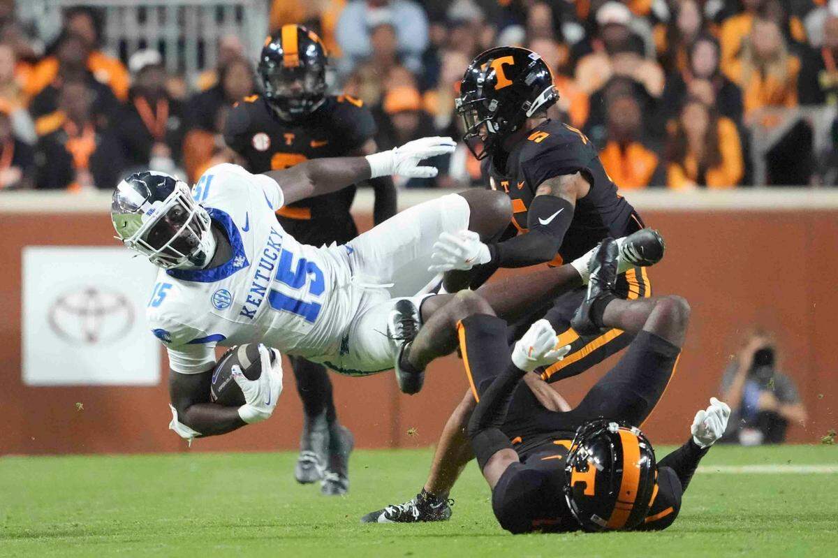 Kentucky tight end Khamari Anderson (15) is tackled by Tennessee defensive back Christian Harrison (5), during a game between Tennessee and Kentucky at Neyland Stadium in Knoxville, Tenn., Saturday, Nov. 2, 2024.