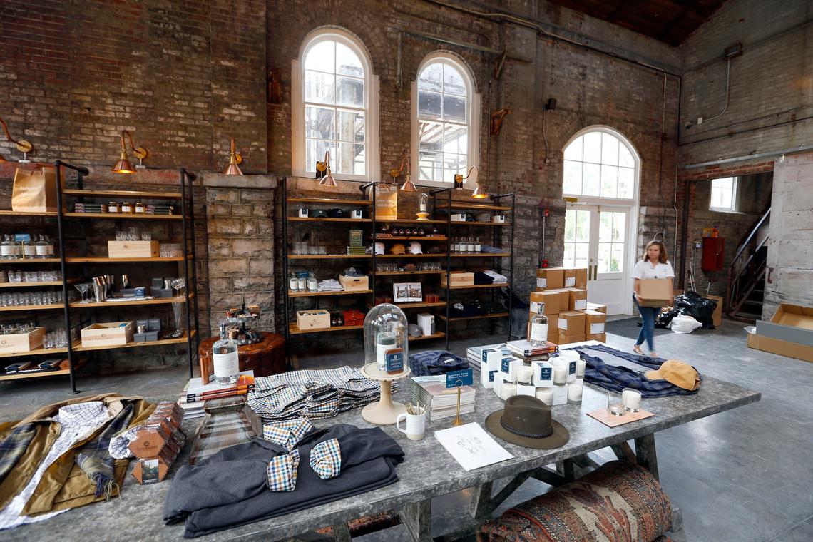 The gift shop at the Castle & Key Distillery has displays of clothing that tastefully displays the distillery logo, plus books about spirits and items for the bourbon lifestyle.