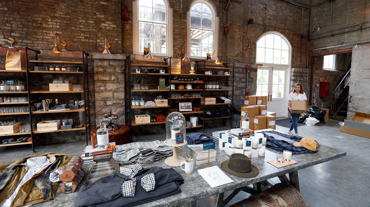The gift shop at the Castle & Key Distillery has displays of clothing that tastefully displays the distillery logo, plus books about spirits and items for the bourbon lifestyle.