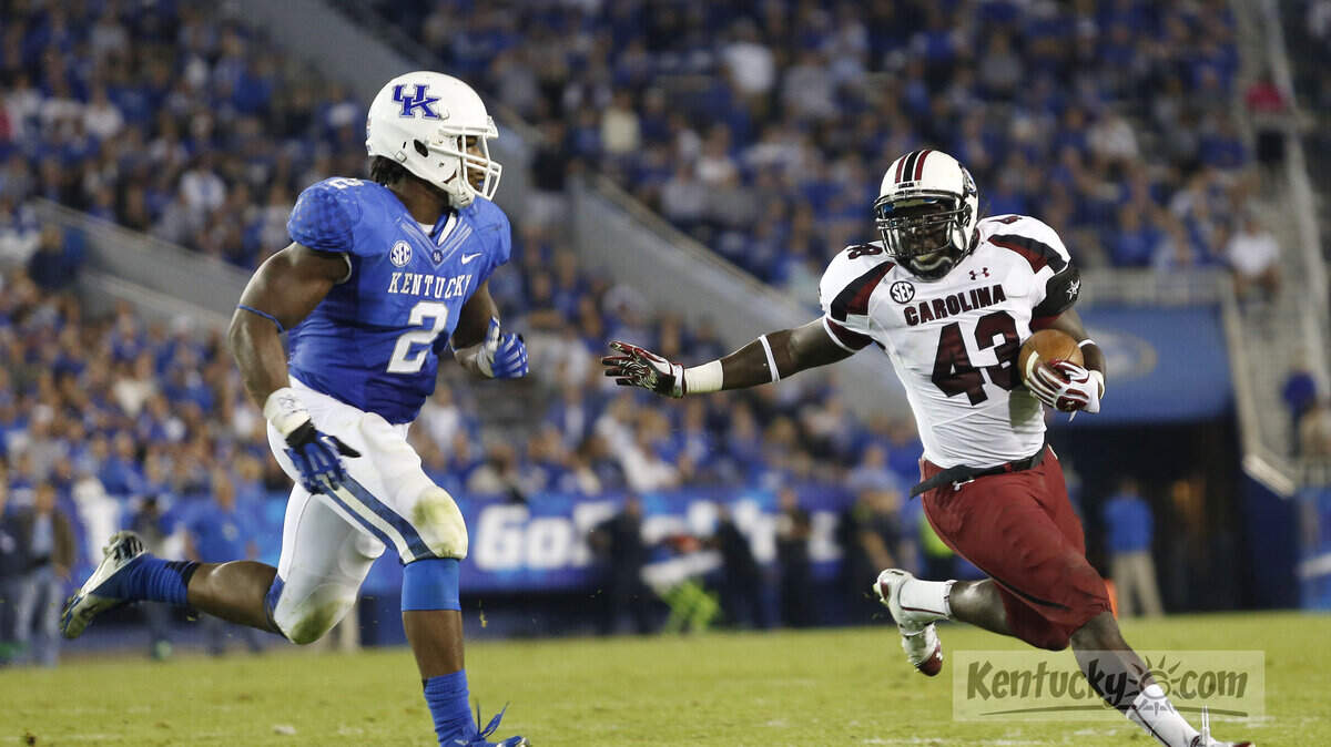 South Carolina Gamecocks fullback Qua Gilchrist (43) carries the ball during the second half at Commonwealth Stadium Sept. 29, 2012 in Lexington, Ky. On defense is Kentucky Wildcats linebacker Alvin Dupree (2). Photo by Amy Wallot