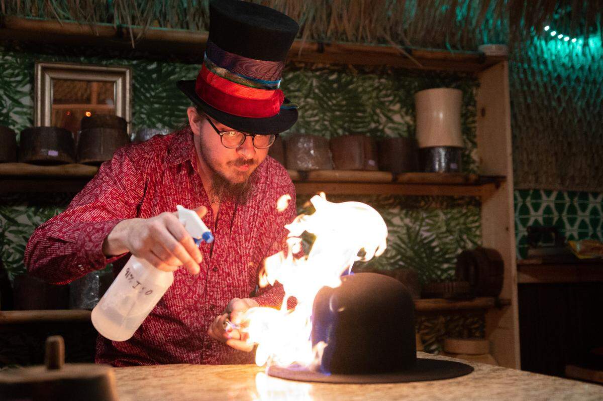 Lexington hatmaker Nick Godbehere uses fire to work the felt of a hat, which is made from sustainably sourced nutria fur.