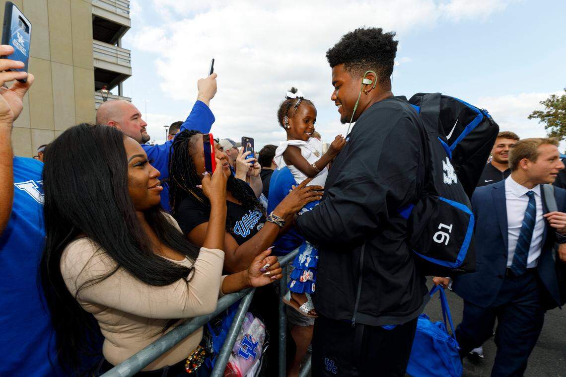Kentucky defensive tackle Calvin Taylor, right hugged his niece, Dallas Williams, during the Cat Walk before UK beat Eastern Michigan 38-17 on Sept. 7.