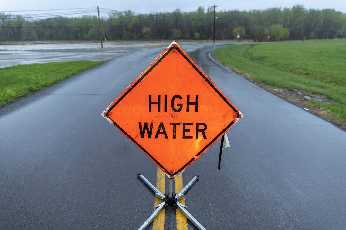 A sign warns drivers of high water along Randolph Street in Liberty, Ky., on Friday, April 4, 2025.