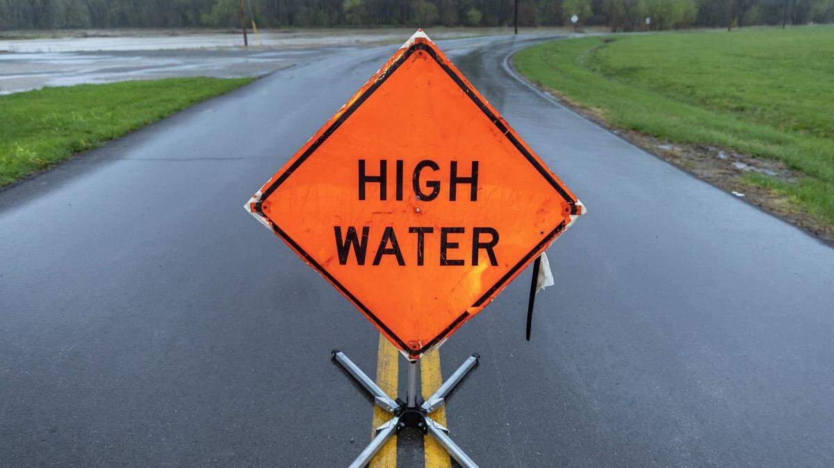 A sign warns drivers of high water along Randolph Street in Liberty, Ky., on Friday, April 4, 2025.