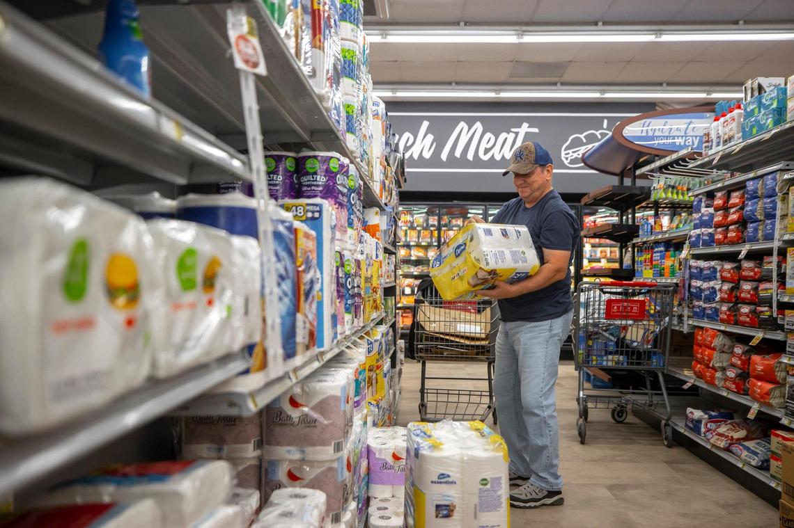 Dale Blair, who was worked at Isom IGA for 41 years, stocks product at the grocery store in Isom, Ky.