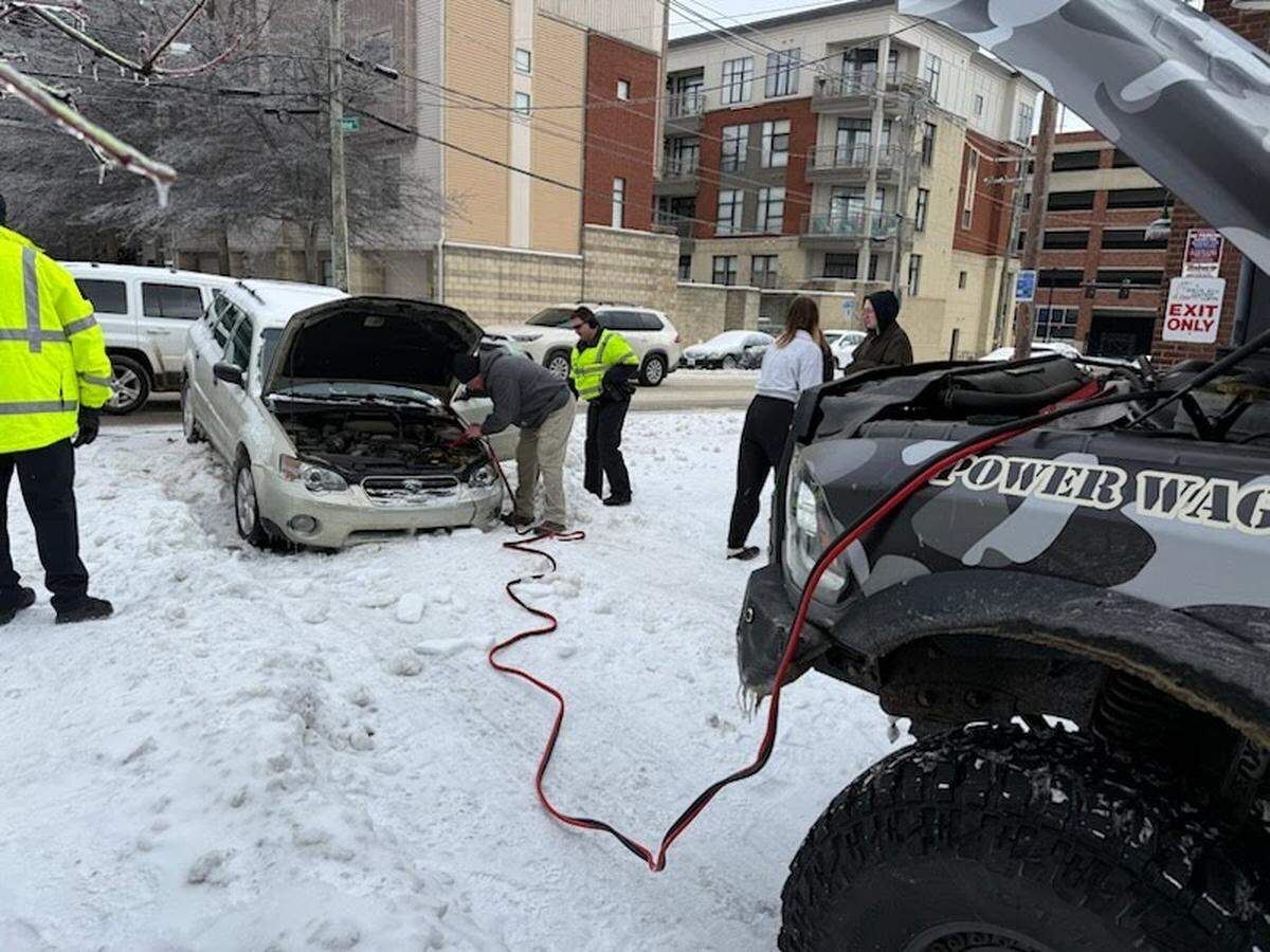 Rocco Besednjak, founder of Camp Hero, gives a car a jump during Winter Storm Fern in Lexington.