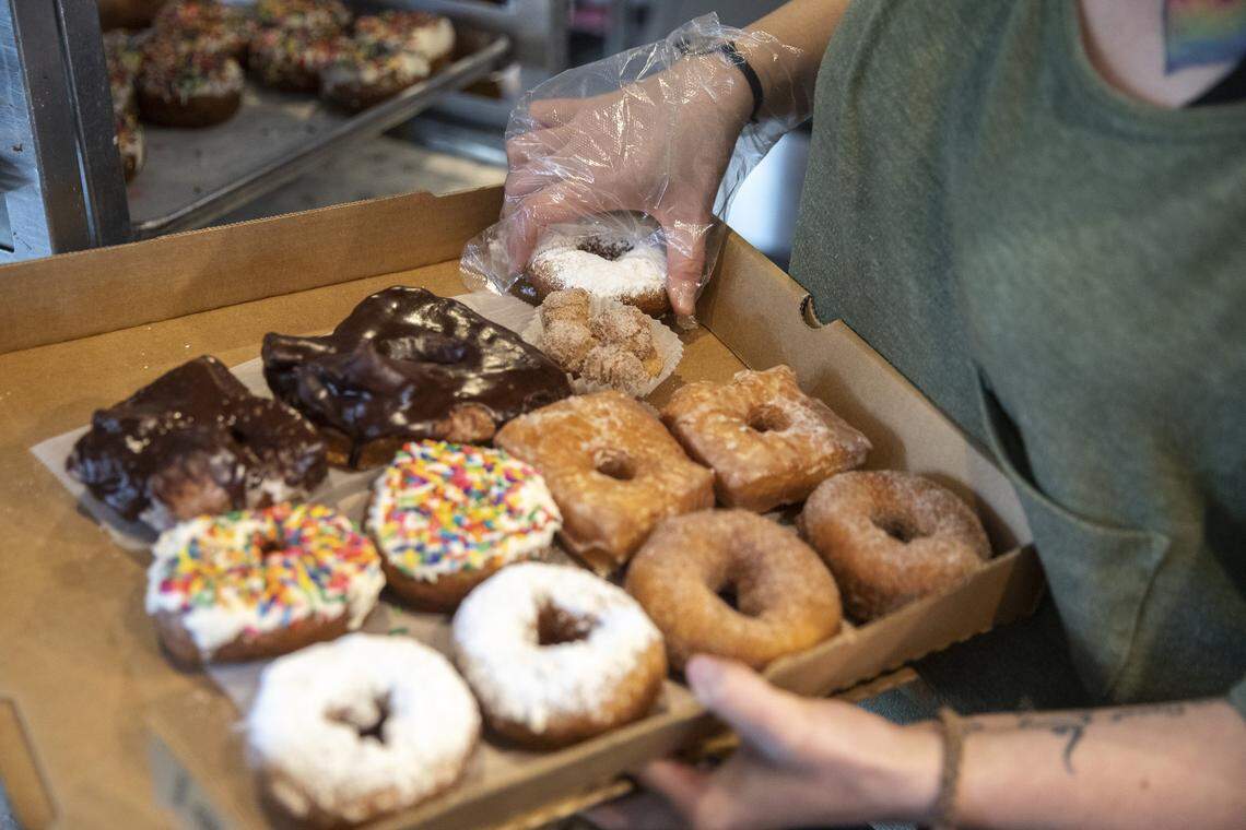 Ciara Simpson, North Lime Coffee & Donuts barista, boxes donuts Thursday, June 6, 2019.