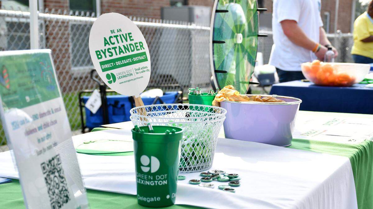 Pins, candy and pens adorn the Green Dot booth during Winburn Public Safety Day on Wednesday, June 28, 2023 at the Community Action Council Center in Lexington, Ky.